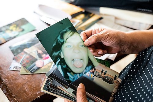 MIKAELA MACKENZIE / WINNIPEG FREE PRESS
 
 Janet Bruyere, grandmother of Fonassa Bruyere (whose body was discovered in a field northwest Winnipeg in 2007), looks at old photos of Fonassa in her home on Sagkeeng First Nation on Tuesday, May 23, 2023. For Shelley story.

Winnipeg Free Press 2023.