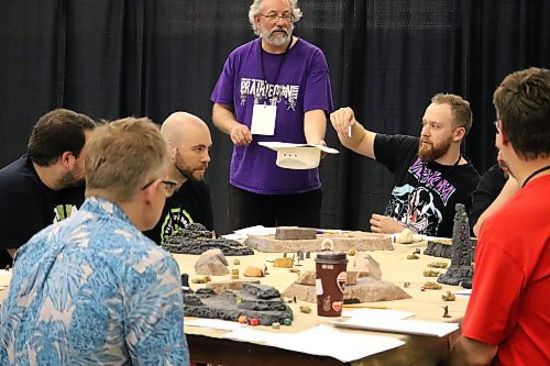 PrairieCon attendees come together to play a game of Desperado at the Brandon Curling Club on Friday afternoon. While this gaming convention had to endure a multi-year hiatus because of the COVID-19 pandemic, organizers returned the event to its classic in-person format last May and are looking to continue that comeback this weekend. (Kyle Darbyson/The Brandon Sun)  