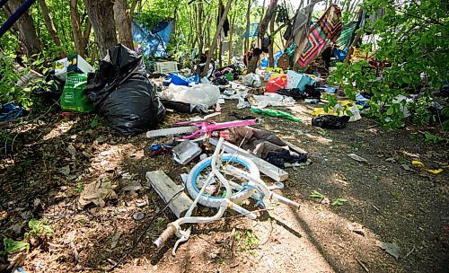 Mike Sudoma/Winnipeg Free Press
Bikes, clothing and other items along the grounds of an encampment along the Red River near Waterfront Drive Friday morning 
May 26, 2023