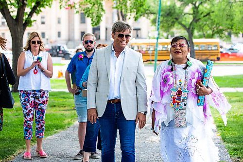 MIKAELA MACKENZIE / WINNIPEG FREE PRESS
 
MLA Kevin Klein walks with Kookum Gayle Pruden to attend the first Pride flag raising outside of the Manitoba Legislative Building (in Memorial Park) on Friday, May 26, 2023.  For Danielle da Silva story.

Winnipeg Free Press 2023.