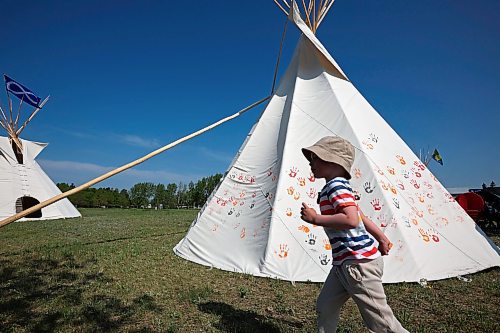 26052023
Four-year-old Killian Gunn of Shilo explores the outside of a teepee during a celebration of the end of Indigenous Awareness Week events at CFB Shilo on Friday. Indigenous Awareness Week is an annual event celebrated nationally throughout the Canadian Armed Forces. 
(Tim Smith/The Brandon Sun)