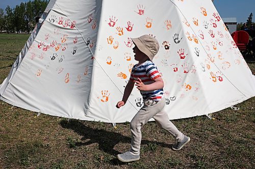 26052023
Four-year-old Killian Gunn of Shilo explores the outside of a teepee during a celebration of the end of Indigenous Awareness Week events at CFB Shilo on Friday. Indigenous Awareness Week is an annual event celebrated nationally throughout the Canadian Armed Forces. 
(Tim Smith/The Brandon Sun)