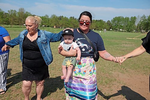 26052023
Master Corporal Cara Sandbe holds her 11-month-old Sawyer Sandbe while taking part in a round-dance celebrating the end of Indigenous Awareness Week events at CFB Shilo on Friday. Indigenous Awareness Week is an annual event celebrated nationally throughout the Canadian Armed Forces. 
(Tim Smith/The Brandon Sun)