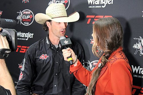 Aaron Roy is interviewed by Alicia Erickson after winning the PBR Canada Cup Series tour stop at Westoba Place on Saturday night. (Lucas Punkari/The Brandon Sun)