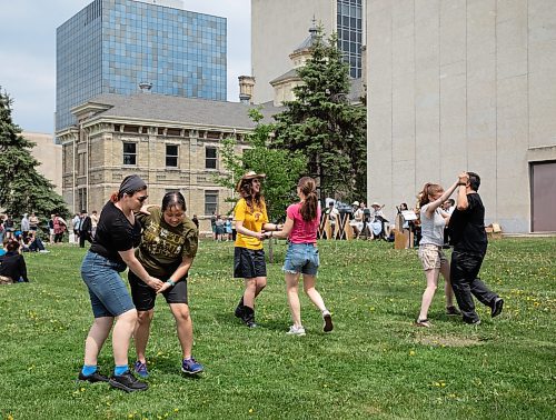 JESSICA LEE / WINNIPEG FREE PRESS

Ashley Blostein (left) and Crystal Jurko (in black) dance with friends May 27, 2023 near Memorial Park while a big band plays.

Stand up