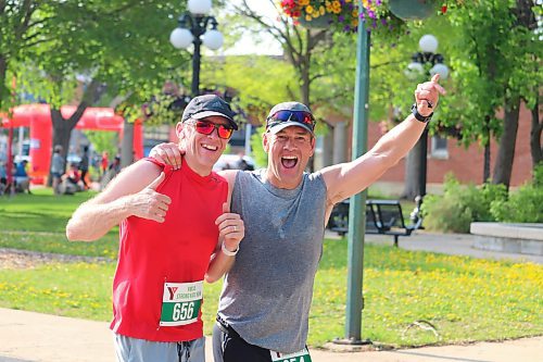 Rob Raville and Laird Lidster pose for a photo mid-stride as they attempt to finish the 20K portion of Sunday's YMCA Strong Kids Run. (Kyle Darbyson/The Brandon Sun)