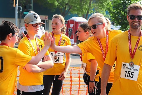 A group from Plumas Elementary School exchanges high fives after completing the 5K portion of Sunday's YMCA Strong Kids Run in Brandon. This race also featured participation from King George School and Dauphin's Whitmore School. (Kyle Darbyson/The Brandon Sun)