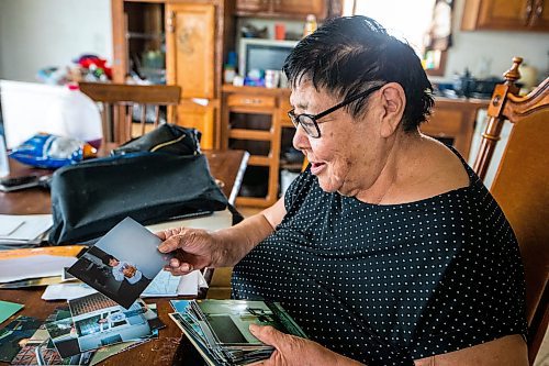 MIKAELA MACKENZIE / WINNIPEG FREE PRESS
 
 Janet Bruyere, grandmother of Fonassa Bruyere (whose body was discovered in a field northwest Winnipeg in 2007), looks at old photos of Fonassa in her home on Sagkeeng First Nation on Tuesday, May 23, 2023. For Shelley story.

Winnipeg Free Press 2023.