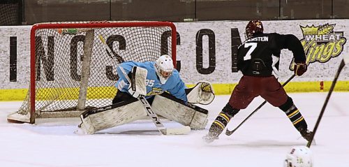 Team Black forward Carter Klippenstein (7) breaks in all alone on Team Gold goaltender Ryder Green (35) during Sunday’s intrasquad game at Brandon Wheat Kings prospects camp at J&G Homes Arena. Green made the save but Klippenstein still tied for the scoring lead at the camp. (Perry Bergson/The Brandon Sun)