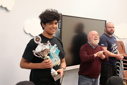 Vincent Massey High School student Martin Riquelme shows off the trophy he won at the Chess'n Math Association's recent national tournament during his usual Saturday meet-up with members of the Brandon Knights Chess Club. (Kyle Darbyson/The Brandon Sun)