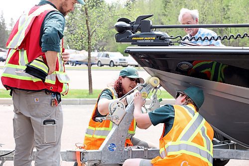 Parks Canada staff inspect and tag boats in Wasagaming last Thursday as part of new Parks Canada restrictions for boaters on Clear Lake. The new rules state boaters must pass an initial inspection before June 15 to receive a permit to use a trailered vessel in Clear Lake and cannot have used their watercraft in any other body of water this year. The restrictions are meant to prevent the spread of invasive species into the lake. (Tim Smith/The Brandon Sun)