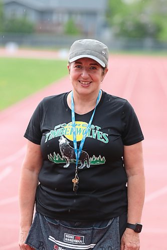 Barb Hildebrand poses in the rain on a wet track at the UCT Stadium just prior to the Rolling River School Division&#x2019;s annual track meet being cancelled mid-afternoon on Monday. The retiring teacher has served as event organizer since 1992. (Perry Bergson/The Brandon Sun)