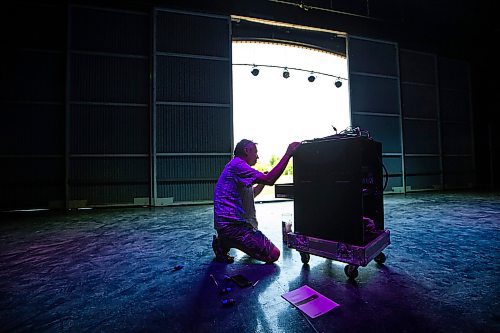 MIKAELA MACKENZIE / WINNIPEG FREE PRESS
 
Matthew Mulla, head of audio at Lyric Stage, builds a new PA system for the Performance Garden at The Leaf in the shade of the Lyric Stage at Assiniboine Park on Monday, May 29, 2023.  Standup.

Winnipeg Free Press 2023.