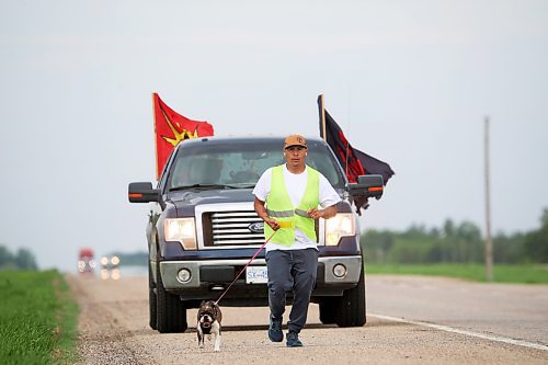 Cameron West jogs along the Trans-Canada Highway toward Carberry with his French bulldog, Gretchen, while his wife, Charity, takes her turn driving the support vehicle Monday morning. The couple are walking across Canada to draw attention to missing and murdered Indigenous people. After they wrap up their cross-country tour, they will trek the Highway of Tears (Highway 16) between Prince Rupert and Prince George, B.C., which has been the location of many missing and murdered Indigenous people. (Tim Smith/The Brandon Sun)