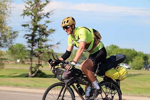 Cross-country cyclist Dariy Khrystyuk rides into Dinsdale Park on Monday evening to greet local members of the Ukrainian community here in Brandon. (Kyle Darbyson/The Brandon Sun)