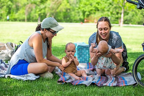 MIKAELA MACKENZIE / WINNIPEG FREE PRESS
 
Kaily Hovius (left) and Sarah Turner play with their babies, Eve Hovius (nine months) and Ezra (no last name given, three months) in the shade at Assiniboine Park on Monday, May 29, 2023.  Standup.

Winnipeg Free Press 2023.