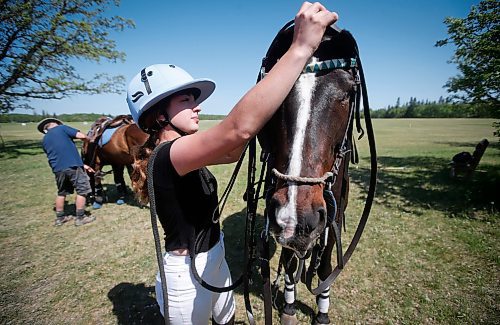 JOHN WOODS / WINNIPEG FREE PRESS
Jenna Trapp, who started polo one year ago, attends to her horse at Springfield Polo Club in Birds Hill Park, Sunday, May 28, 2023. 

Reporter: sanderson