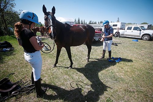 JOHN WOODS / WINNIPEG FREE PRESS
Regan Smith, who&#x2019;s been playing polo since 5, and works and plays polo in the family business/team Rocking S Polo and Jenna Trapp, who started polo one year ago, attend to her horse at Springfield Polo Club in Birds Hill Park, Sunday, May 28, 2023. 

Reporter: sanderson