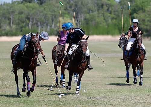 JOHN WOODS / WINNIPEG FREE PRESS
Regan Smith, centre, who&#x2019;s been playing polo since 5, and works and plays polo in the family business/team Rocking S Polo goes for the ball during a clinic at Springfield Polo Club in Birds Hill Park, Sunday, May 28, 2023. 

Reporter: sanderson