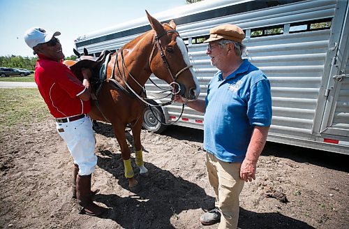 JOHN WOODS / WINNIPEG FREE PRESS
Canelo Rafael, a professional polo player from Mexico, left, and Gary Senft, who&#x2019;s been playing polo for 49 years, attend to Rafael&#x2019;s horse Cartel at Springfield Polo Club in Birds Hill Park, Sunday, May 28, 2023. 

Reporter: sanderson