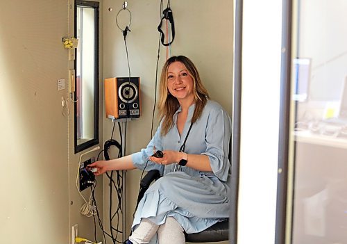Allison Clee, a hearing instrument specialist with Hear Canada, adjusts the levels on hearing test equipment in an audio booth at the organization's office in Brandon on Tuesday (Michele McDougall/The Brandon Sun)