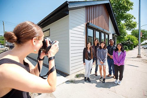 Mike Deal / Winnipeg Free Press
Students from left: Elissa Guimond, Logan Harvey, Erica Guimond, Orlando Harper, and Kirklynn Harper get their photo taken by Alana Ollinger community organizer at CEDA, during the opening ceremony for Niiwin Minisiwiwag school, located at 383 Selkrik Avenue.
The Indigenous Education Caring Society is unveiling a new alternative school campus for First Nations, Metis and Inuit learners who've become disengaged with school in a bid to re-capture their attention, re-engage them and support them to graduate. The special North End site called, Niiwin Minisiwiwag, located at 383 Selkrik Avenue, is run via MOU/partnership with WSD, will support teens to complete their high school education. The aim is to find 'inactive students' (students that WSD receives funding for, but who have become lost in the system and don't currently attend classes). It's no secret COVID has worsened attendance in recent years. This project is a grassroots effort to make a dent in the issue of chronic absenteeism. The society is an initiative between Ma Mawi Wi Chitata Centre, Ndinawemaaganag Endawaad and the Community Education Development Association (CEDA). The newly-finished building was funded by a $500K grant from the Winnipeg Foundation, and grants from an anonymous donor and Sill Foundation, City of Winnipeg donated the land. We are getting an exclusive preview because of our ed coverage. 
See Maggie story
230530 - Tuesday, May 30, 2023.