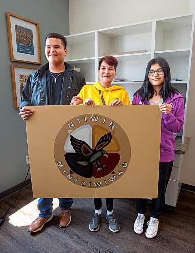 Mike Deal / Winnipeg Free Press
Orlando Harper, student and artist who helped design the school logo, with his mother, Mary Brenda Harper and sister, Kirklynn Harper, during the opening ceremony for Niiwin Minisiwiwag school, located at 383 Selkrik Avenue.
The Indigenous Education Caring Society is unveiling a new alternative school campus for First Nations, Metis and Inuit learners who've become disengaged with school in a bid to re-capture their attention, re-engage them and support them to graduate. The special North End site called, Niiwin Minisiwiwag, located at 383 Selkrik Avenue, is run via MOU/partnership with WSD, will support teens to complete their high school education. The aim is to find 'inactive students' (students that WSD receives funding for, but who have become lost in the system and don't currently attend classes). It's no secret COVID has worsened attendance in recent years. This project is a grassroots effort to make a dent in the issue of chronic absenteeism. The society is an initiative between Ma Mawi Wi Chitata Centre, Ndinawemaaganag Endawaad and the Community Education Development Association (CEDA). The newly-finished building was funded by a $500K grant from the Winnipeg Foundation, and grants from an anonymous donor and Sill Foundation, City of Winnipeg donated the land. We are getting an exclusive preview because of our ed coverage. 
See Maggie story
230530 - Tuesday, May 30, 2023.