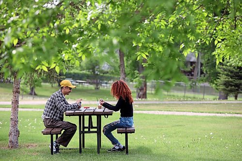 30052023
Anmol Singh and Ruth Birhane play Uno at a picnic table in Rideau Park on a hot Tuesday evening. 
(Tim Smith/The Brandon Sun)