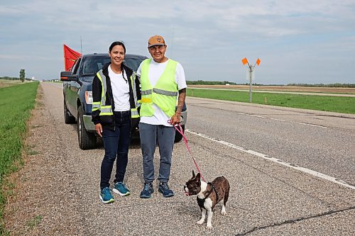 Charity and Cameron West, photographed on the Trans-Canada Highway just west of Carberry with their French bulldog Gretchen, are walking across Canada to draw attention to missing and murdered Indigenous people. They began their first leg of the walk in Siksika Nation in southern Alberta and are walking to St. John's, N.L. From there they will begin their second leg in Prince Rupert, B.C., and walk the Highway of Tears on Highway 16, where several Indigenous Canadians have gone missing, home to Prince George. They average approximately 40 to 50 kilometres a day. (Photos by Tim Smith/The Brandon Sun)