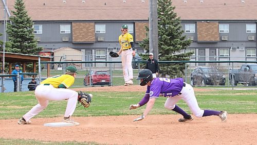 Vincent Massey Vikings base runner Jayce Thompson (21) dives back into first base safely as Boissevain-Wawanesa’s Tyler Robertson (20) catches the ball after a pickoff attempt by pitcher Connor Martin (27) during a 15-6 Boissevain victory at Andrews Field on May 7. The two teams both begin play today at high school provincials in Glenboro and Baldur. The semifinals and final are in Glenboro on Saturday morning. (Perry Bergson/The Brandon Sun)