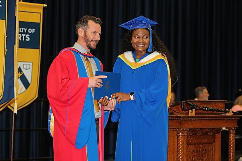 Valentina Eigbiremonlen accepts her Bachelor of Science degree from Acting Dean of Science Christophe LeMoine during Thursday morning's convocation ceremony at the Healthy Living Centre. (Kyle Darbyson/The Brandon Sun) 