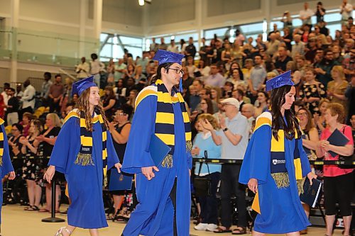Brandon University's Class of 2023 exit the Healthy Living Centre's main gymnasium to "Pomp and Circumstance" after receiving their diplomas during Thursday morning's convocation ceremony. (Kyle Darbyson/The Brandon Sun) 