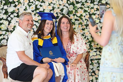 Brandon University graduates meet up with friends and family at Harvest Hall to take photos after Thursday morning's convocation ceremony wraps up. (Kyle Darbyson/The Brandon Sun)