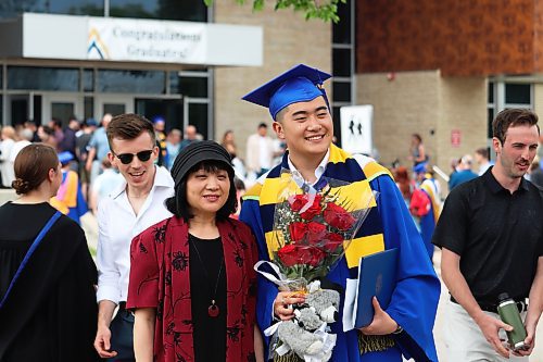 Brandon University graduates meet up with friends and family outside the Healthy Living Centre after Thursday morning's convocation ceremony comes to a close. (Kyle Darbyson/The Brandon Sun)