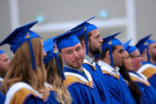 A Faculty of Education student speaks with a friend beside him shortly after the convocation processional on Thursday afternoon at the Healthy Living Centre. (Matt Goerzen/The Brandon Sun)