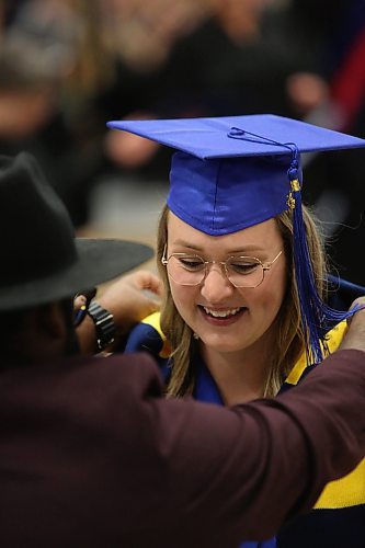 A Faculty of Education graduate receives a scarf with the colours of Brandon University during the Thursday afternoon convocation ceremony at the Healthy Living Centre. (Matt Goerzen/The Brandon Sun)