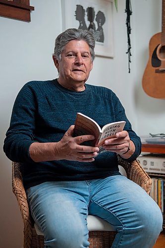 ETHAN CAIRNS / WINNIPEG FREE PRESS
Neil Besner an English Professor; Provost and Vice-President at the university of Winnipeg is pictured in his home holding his new book, Fishing With Tardelli in Winnipeg, Manitoba on Tuesday May 31, 2022. For Ben Sigurdson story
