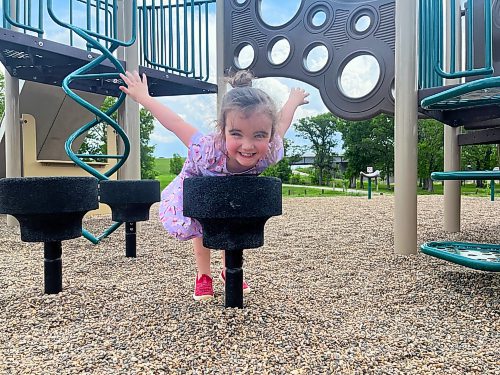 Three-year-old Emily Johnson takes flight to keep cool at Dinsdale Park's playground in Brandon on Friday. (Michele McDougall/The Brandon Sun)