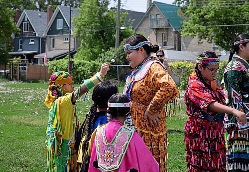 JESSICA LEE / WINNIPEG FREE PRESS

From left to right: Lorenzo, Jordan, Aubree and Peyton gather during the grand entrance of a pow wow celebrating the five year anniversary of West Broadway Bear Clan at West Broadway Neighbourhood Centre June 3, 2023.

Reporter: Malak Abas