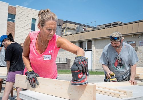 JESSICA LEE / WINNIPEG FREE PRESS

Karen Guercio (left), advisor, sands beds with Albert Guercio. Several dozen students, teachers and community members at Shaftesbury High School gathered June 3, 2023 to build beds to end child bedlessness in Winnipeg.

Stand up