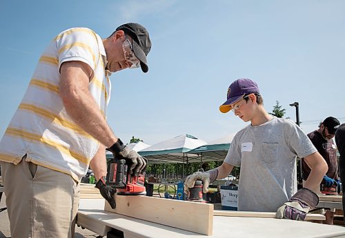 JESSICA LEE / WINNIPEG FREE PRESS

Grant Prairie (left) and his son Isaac Prairie-Cherniack, 11, sand bed parts. Several dozen students, teachers and community members at Shaftesbury High School gathered June 3, 2023 to build beds to end child bedlessness in Winnipeg.

Stand up