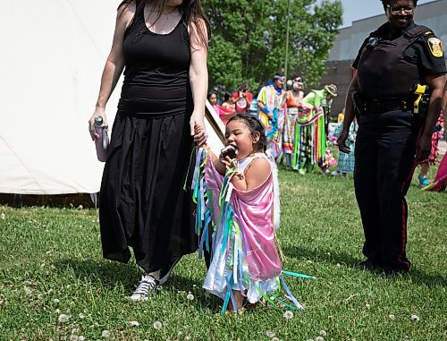 JESSICA LEE / WINNIPEG FREE PRESS

A hungry visitor eats an ice cream sandwich while walking during the grand entrance of a pow wow celebrating the five year anniversary of West Broadway Bear Clan at West Broadway Neighbourhood Centre June 3, 2023.

Reporter: Malak Abas