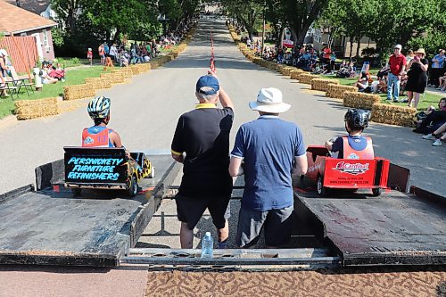 A pair of Kiwanis Kar Derby racers glide down the starting ramp during the opening minutes of Saturday’s competition, which took place at the corner of Rideau Street and Lorne Avenue East in Brandon. This year’s contest marks the first time that the Kiwanis Club of Brandon has been able to organize its Kar Derby since 2019. (Kyle Darbyson/The Brandon Sun)