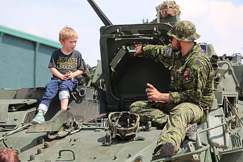 Master bombardier Bordie Lawrence, currently stationed at CFB Shilo, shows Grayson Kolody the ins and outs of a LAV 6 armoured carrier during the Commonwealth Air Training Plan Museum’s grand reopening on Sunday. (Kyle Darbyson/The Brandon Sun)