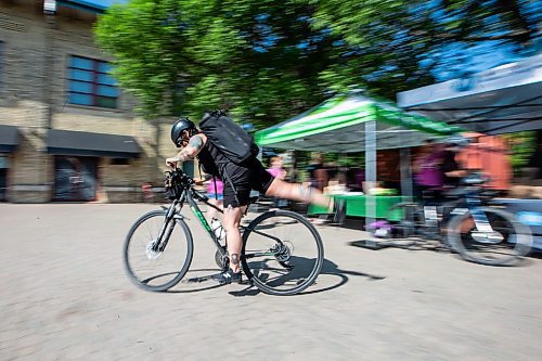 MIKAELA MACKENZIE / WINNIPEG FREE PRESS
Cyclist Sharon Humphrey bikes away from a Bike Week booth at The Forks on Monday, June 5, 2023. This is the 15th annual Bike to Work Day. Standup.
Winnipeg Free Press 2023