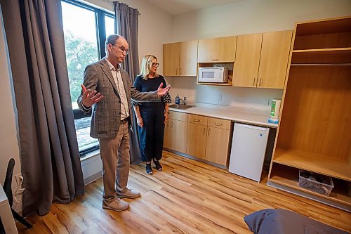 Mike Deal / Winnipeg Free Press
John Pollard, president, Home First Winnipeg, gives Families Minister Rochelle Squires a tour of a couple of the apartments in the building.
Manitoba Families Minister Rochelle Squires along with Mayor Scott Gillingham, Mental Health and Community Wellness Minister Janice Morley-Lecomte, John Pollard, president, Home First Winnipeg, and Jason Whitford, president and CEO, End Homelessness Winnipeg during the opening of a new three-storey micro-suite apartment building, 390 Ross Street, to support people with mental health or addiction issues who are experiencing homelessness or at risk of experiencing homelessness. 
230605 - Monday, June 05, 2023.