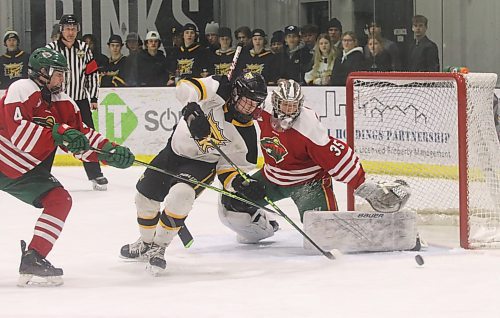 Winnipeg Wild Red goalie Dylan McFadyen (35) defends against Brandon Wheat Kings forward Cole Dupuis (11) under the watchful eye of defenceman Colin Krestanowich (4) and referee Mike Godfrey during Game 2 of the Winnipeg U15 AAA Hockey League’s best-of-seven final on March 11 at J&G Homes Arena. (Perry Bergson/The Brandon Sun)