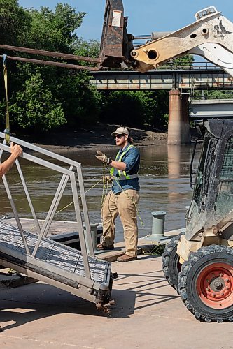 Mike Thiessen / Winnipeg Free Press Caleb Wright with Seaco Marine installing the summer docks at The Forks Historic Port. 230606 &#x2013; Tuesday, June 6, 2023