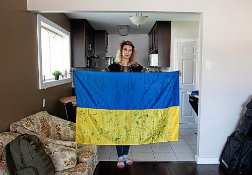 JESSICA LEE / WINNIPEG FREE PRESS

Widower Hanna Sidorchenko holds a Ukrainian flag signed by 30 of her deceased husband&#x2019;s fellow soldiers, in her Winnipeg apartment June 7, 2023. Only two are alive. Sidorchenko&#x2019;s husband died a few weeks ago fighting in the war in Ukraine. She went back to her home country try to bring his body to Canada but couldn&#x2019;t access where he died because it is a Russian controlled area.

Reporter: Kevin Rollason