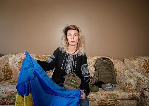 JESSICA LEE / WINNIPEG FREE PRESS

Widower Hanna Sidorchenko holds a Ukrainian flag signed by 30 of her deceased husband&#x2019;s fellow soldiers, in her Winnipeg apartment, surrounded by his belongings June 7, 2023. Only two of the thirty that signed the flag are alive. Sidorchenko&#x2019;s husband died a few weeks ago fighting in the war in Ukraine. She went back to her home country try to bring his body to Canada but couldn&#x2019;t access where he died because it is a Russian controlled area. 

Reporter: Kevin Rollason